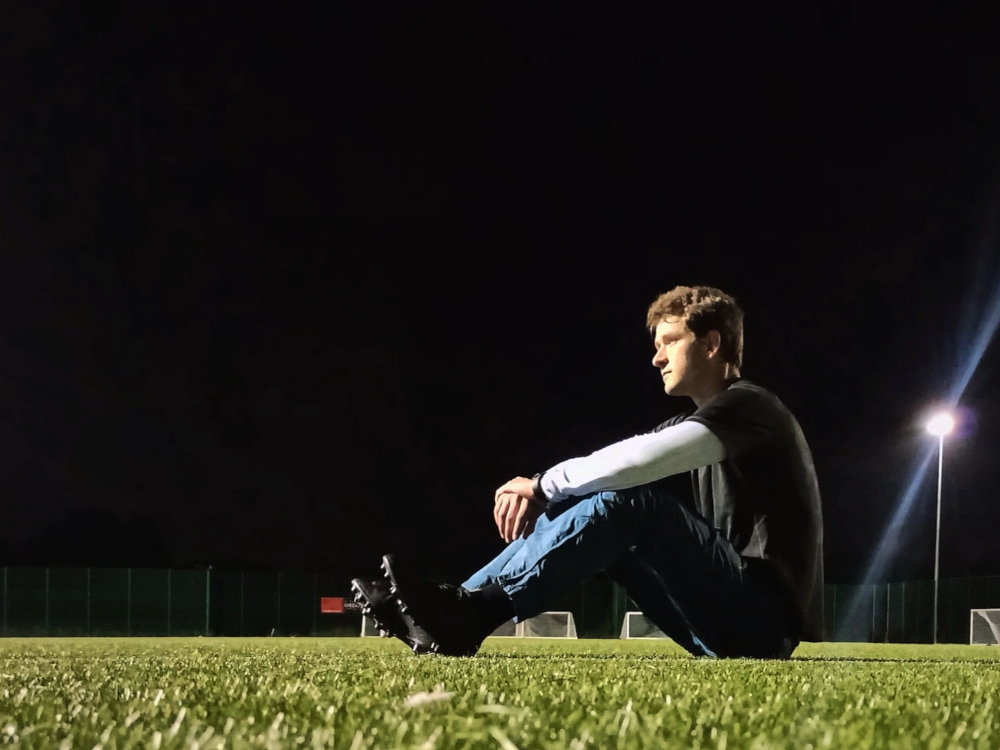 Photograph of Edward Rycroft resting at half-time during a match of football in London, United Kingdom.